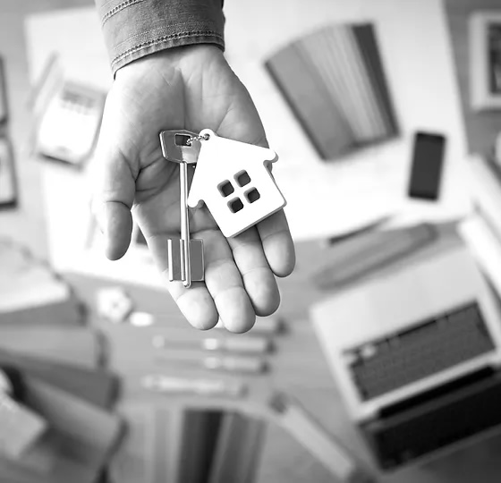 hand offering key to a new home
